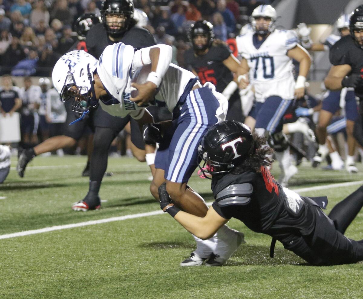 L.D. Bell’s Cameron Johnson is dragged down during a UIL football game at Pennington Field on Thursday, November 7, 2024.