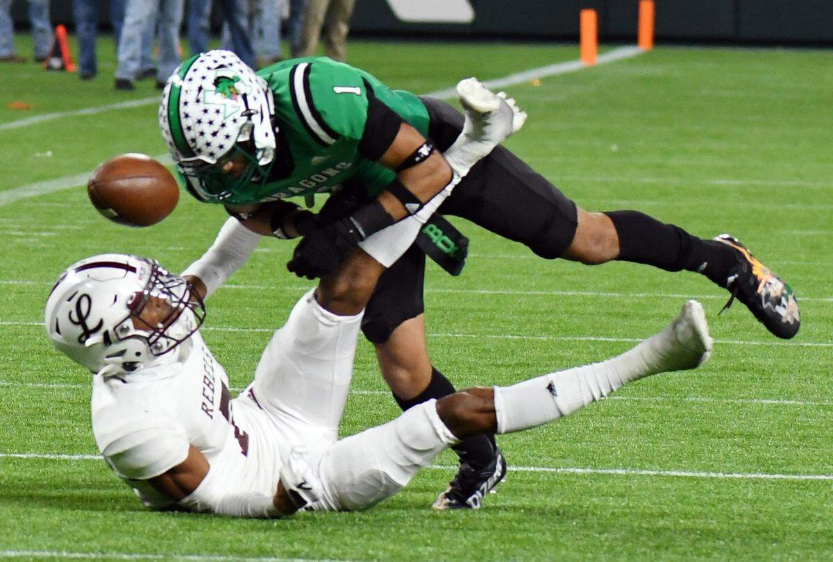 Midland Legacy’s Chris Brazzell, left, has his pass broken up by Southlake Carroll’s Avyonne Jones in the first quarter of their Class 6A Division 1 Area football game Saturday, November 20, 2021 at Globe Life Field in Arlington, Texas. Special/Bob Haynes