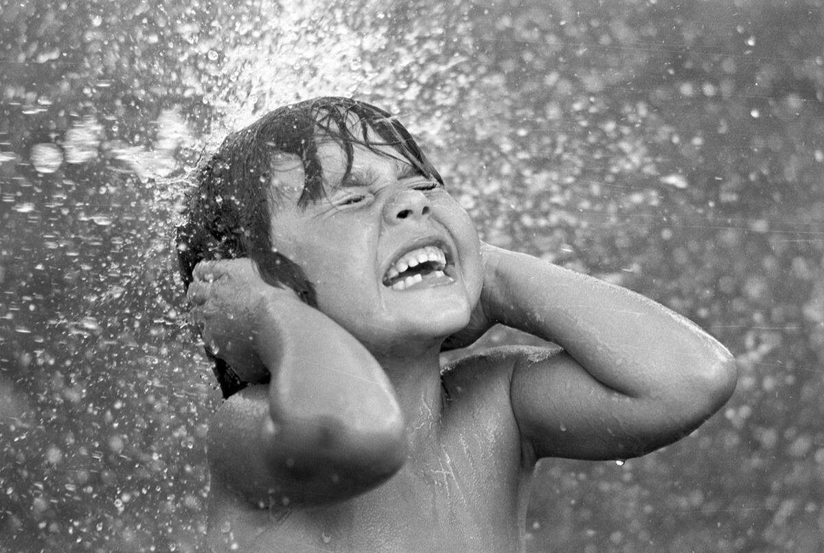 June 16, 1980: Adam Coca, 6, is splashed during a water battle as the high temperature hit 100 degrees in Fort Worth.
