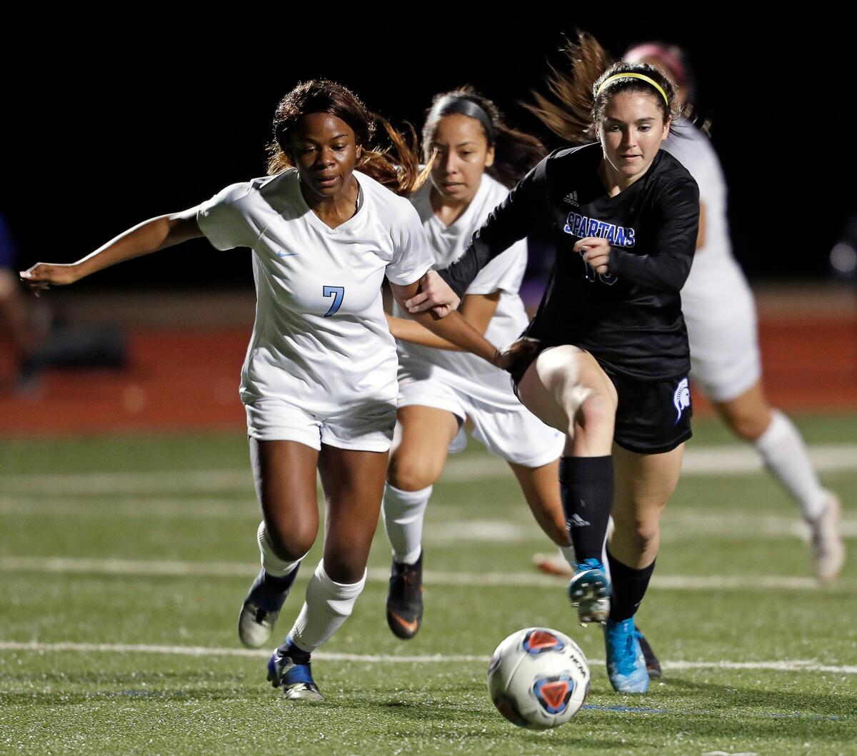Juan Seguin’s Newjada Hamilton and Centennial’s Ashli Galupi chase the ball across the pitch in the second half of a high school soccer game at Centennial High School in Burleson, Texas, Tuesday, March 10, 2020. Centennial defeated Juan Seguin 9-0. (Special to the Star-Telegram Bob Booth)