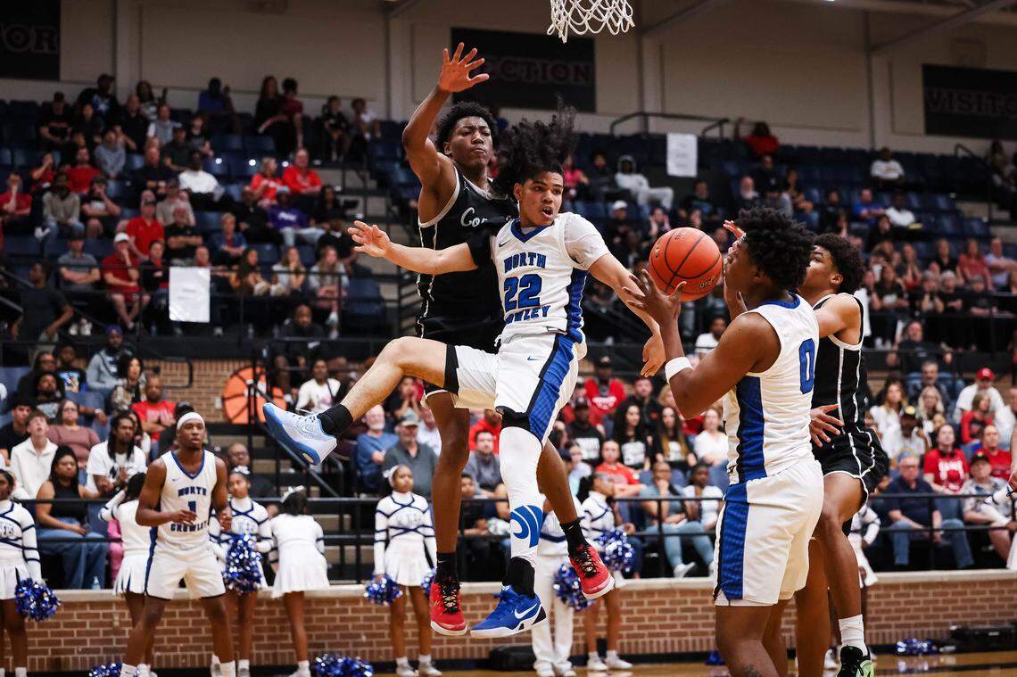 North Crowley guard Isaak Hayes (22) passes the ball while leaping in the air against a Coppell defender to his teammate Bennjamin Jones (0) in a UIL 6A D1 regional semifinal at Timberview High School on Tuesday, March 3, 2026.