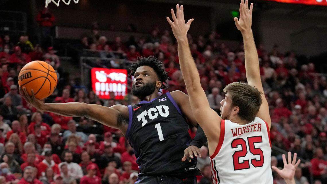 TCU guard Mike Miles Jr. (1) goes to the basket as Utah guard Rollie Worster (25) defends their game Wednesday.