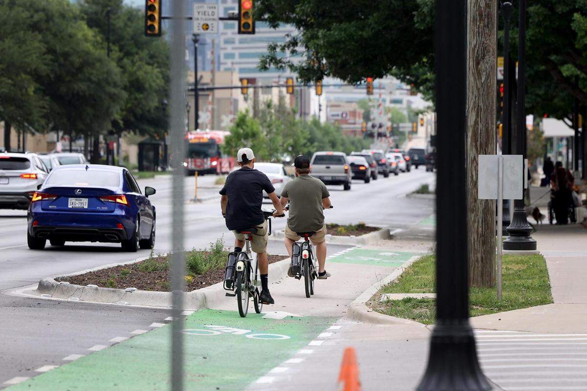 Cyclists ride on the protected bike lane on West 7th Street in Fort Worth on Tuesday, April 18, 2023. Fort Worth taxpayers spent $8.5 million for road improvements on a stretch of West 7th Street between University Drive and the Trinity River.