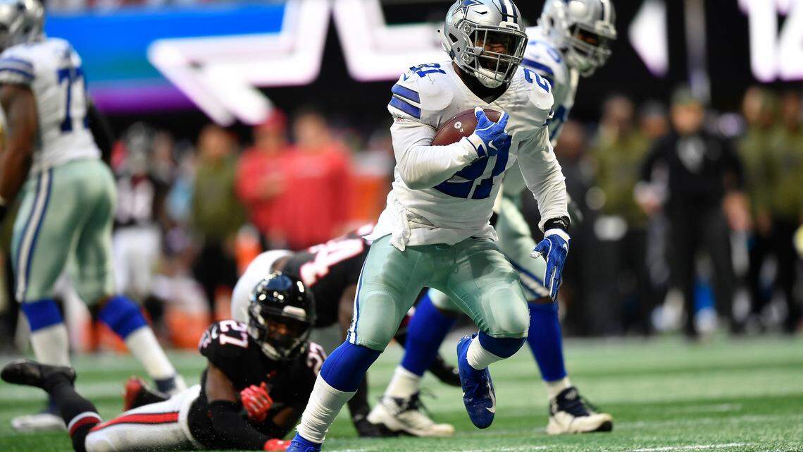 Dallas Cowboys running back Ezekiel Elliott (21) moves past Atlanta Falcons strong safety Damontae Kazee (27) on his way to a touchdown during the second half of an NFL football game, Sunday, Nov. 18, 2018, in Atlanta.