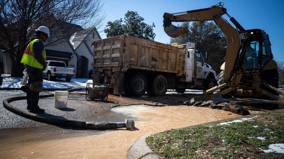 A crew repairs a water main break in Ridglea neighborhood of Fort Worth after the winter storm and severe cold caused numerous breaks around the city.