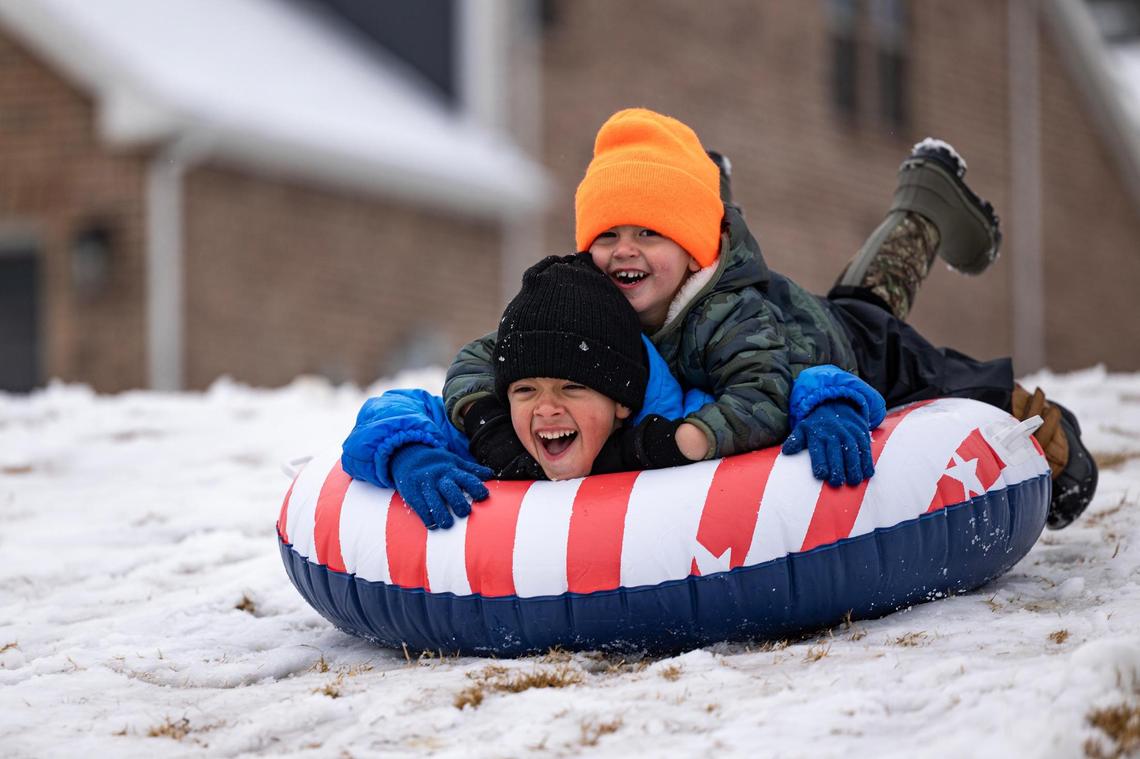 Brothers Nixon, 5, and Nyles Pickering, 2, sled down a hill in a tube float in their neighborhood park in southwest Fort Worth on Friday, Jan. 10, 2025.