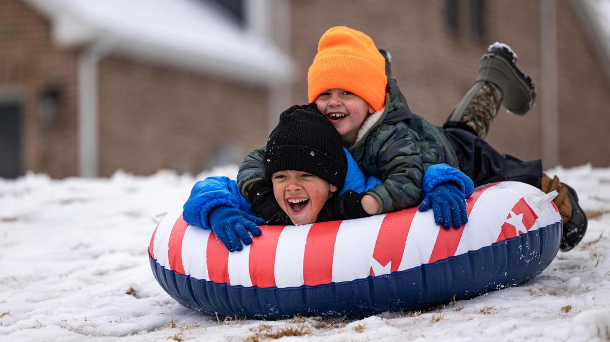 Brothers Nixon, 5, and Nyles Pickering, 2, sled down a hill in a tube float in their neighborhood park in southwest Fort Worth on Friday, Jan. 10, 2025.