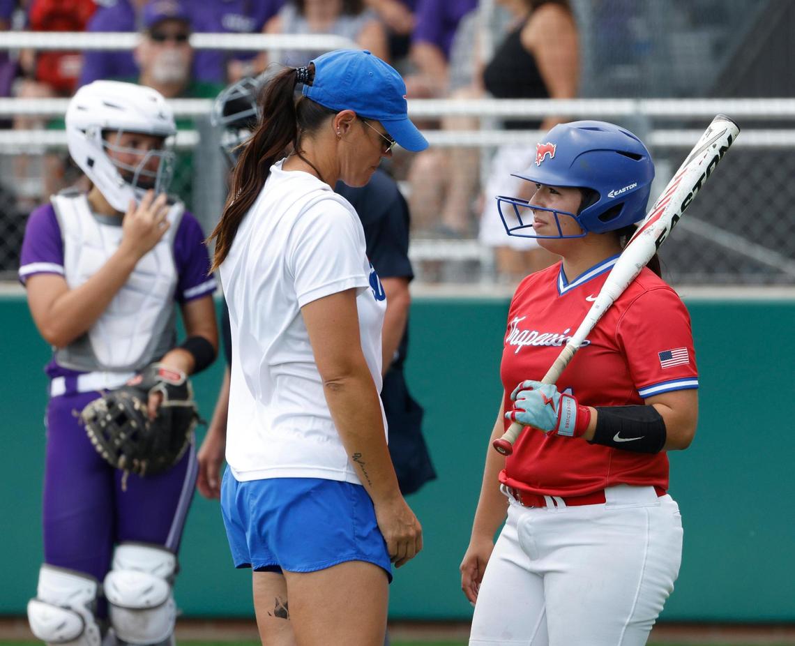 Grapevine head coach Christina Gwyn talks with right fielder Bella Vaquera (11) before her at-bat during game 2 of the UIL softball semifinal 5A D2 playoffs at The Rabbit Hole in Forney, Texas, Saturday, May 24, 2025.