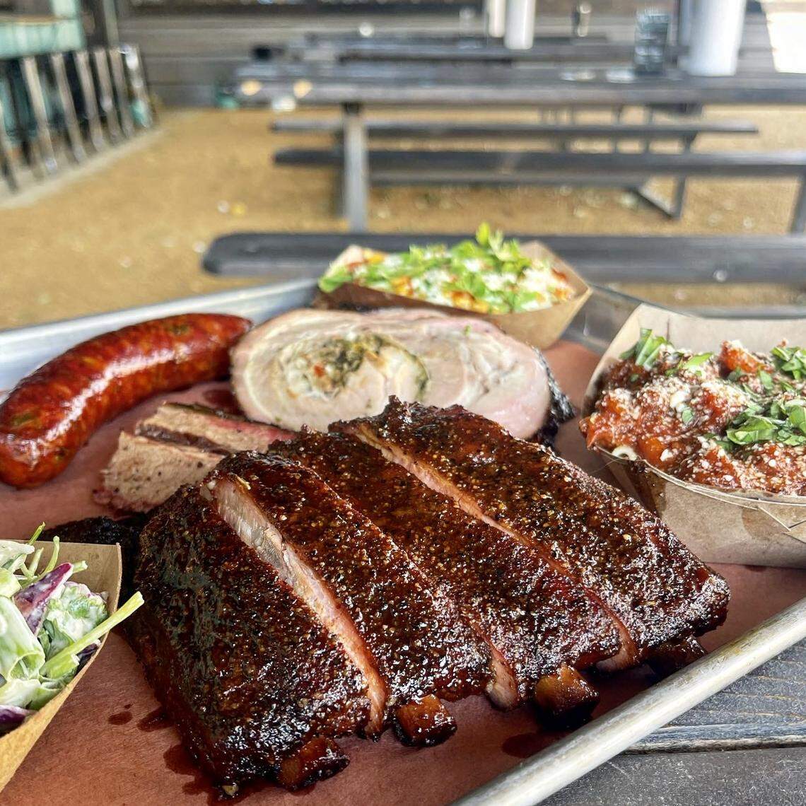 Ribs, stuffed pork belly,. sausage and sides at Brix Barbecue in Fort Worth.