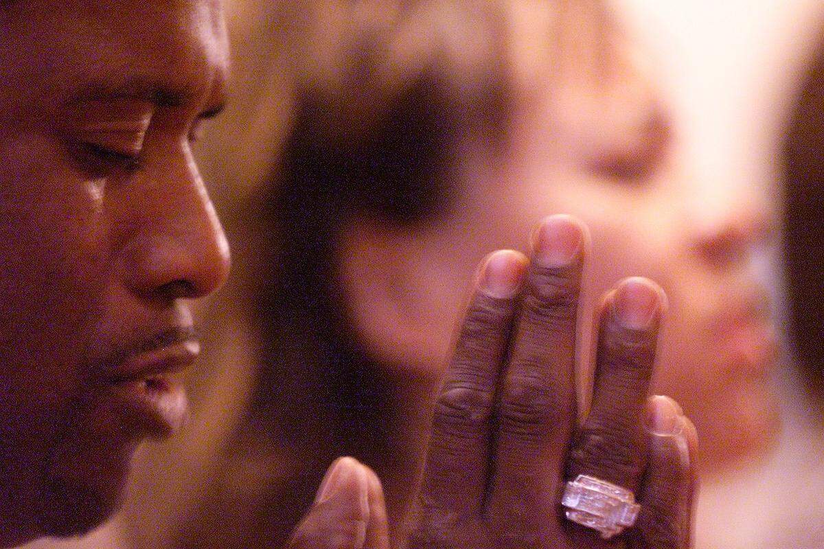 Keenan Williams, 30, left, prays with Alicia Johnson, right, during a prayer vigil at Rising Star Baptist Church in Fort Worth in memory of the many people affected by the terrorist attacks on the East Coast on Sept. 11, 2001.