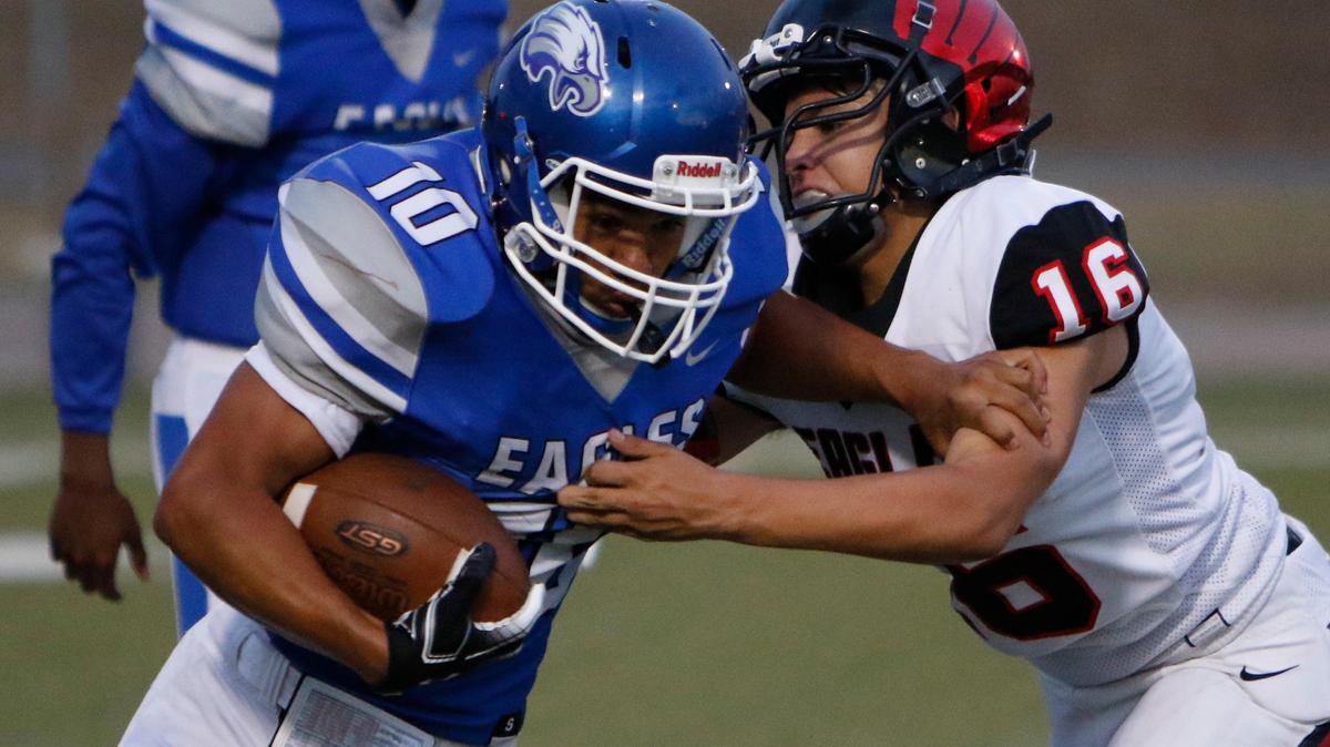 Carter Riverside running back Gustavo Puente (10) tries to get past Diamond Hill-Jarvis defender Tre Sheffield (16). The Diamond Hill-Jarvis Eagles played the Carter-Riverside Eagles at Scarborough-Handley Field in Fort Worth Friday, Sept. 20, 2019.