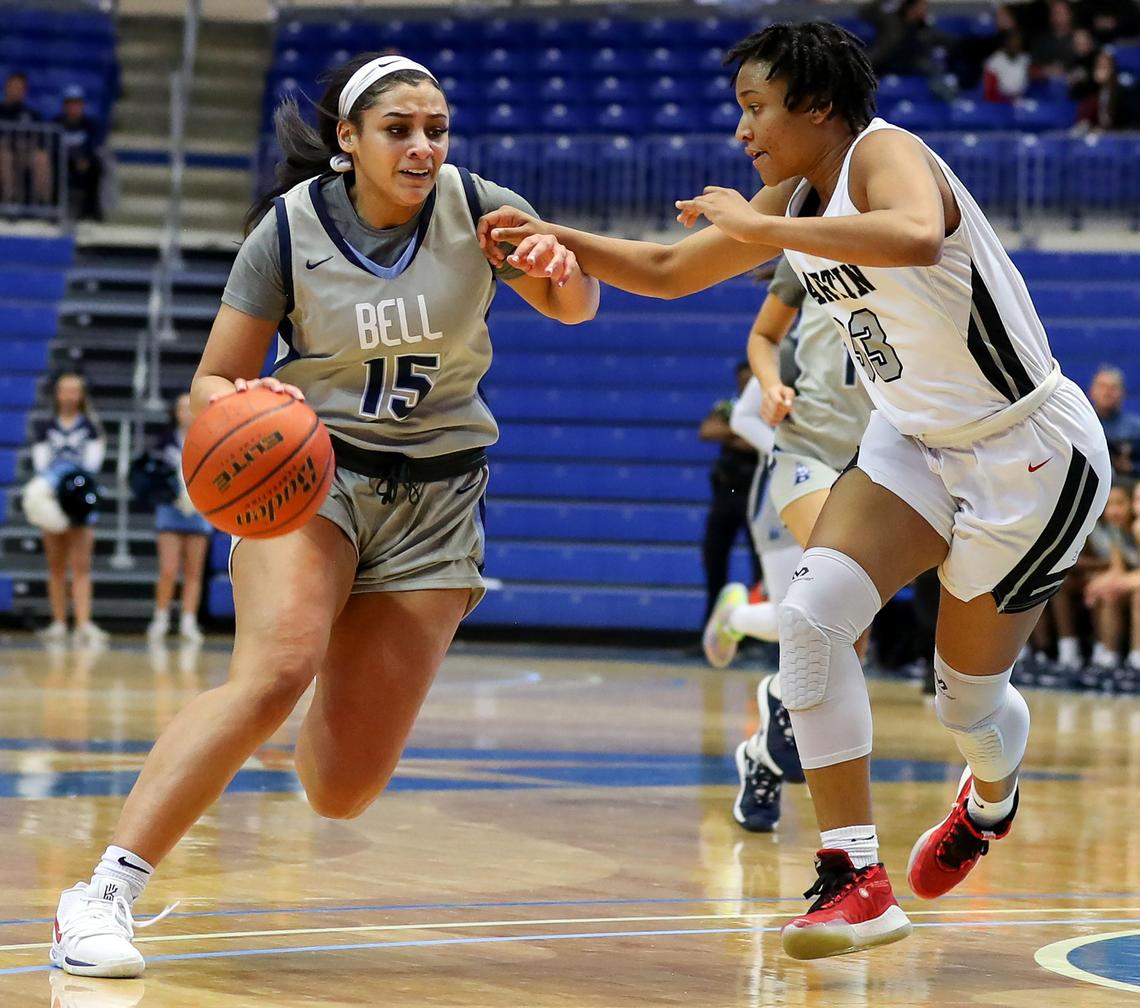 L.D. Bell guard Myra Gordon (15) drives strong to the basket against Arlington Martin guard Ariana Bracey (33) during the first half of the Girls Regional Quarterfinal Playoff basketball game, Tuesday, February 25, 2020 at the College Park Center on the UTA campus in Arlington, Texas.