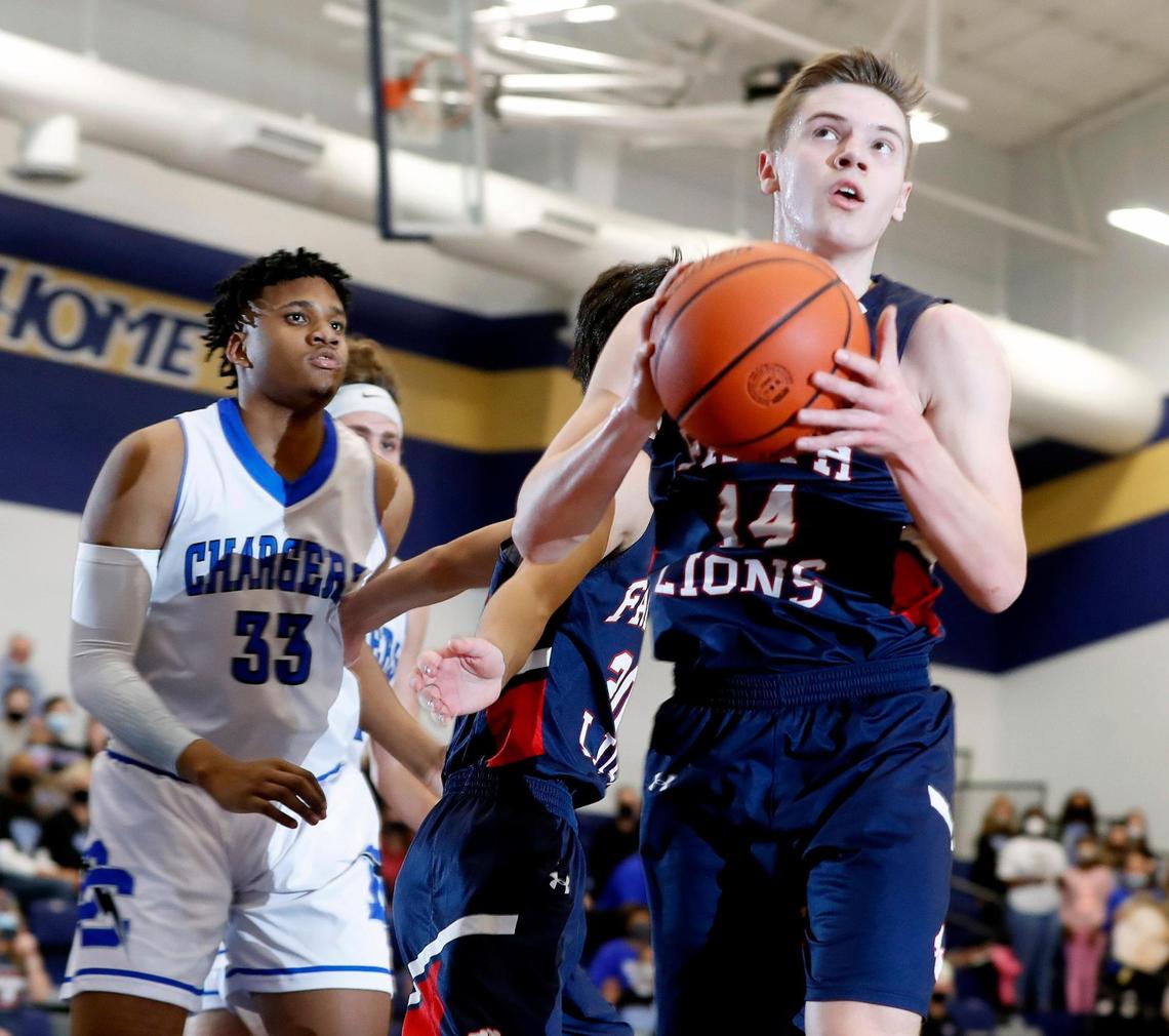 Grapevine Faith’s Grant Rein (14) gets a look aead of Dallas Christian post Johnny Morris (33) during the TAPPS 5A regional basketball playoff game at Grace Prep in Arlington, Texas, Saturday, March 06, 2021. Grapevine Faith defeated Dallas Christian 52-48. (Special to the Star-Telegram Bob Booth)
