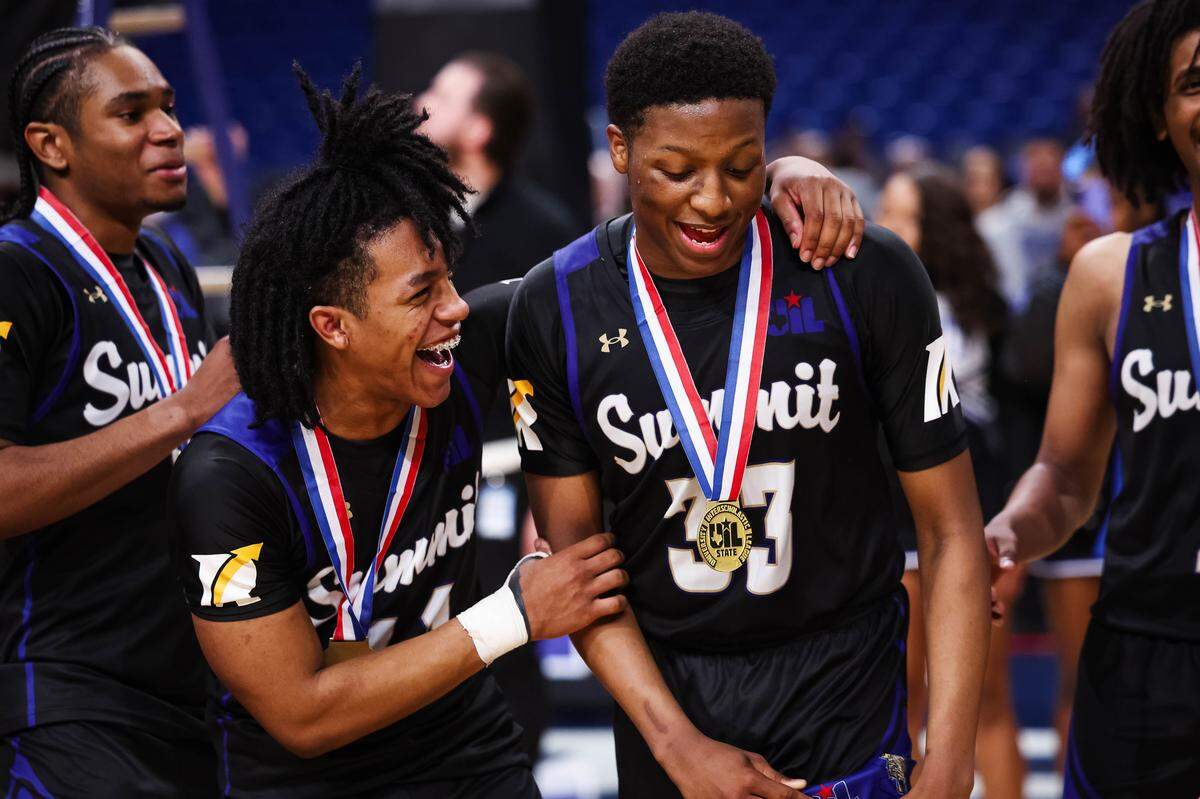 Mansfield Summit guards Javon Ross (33) and Sebastian Pena laugh and celebrate together after winning the Class 5A Division II state championship game against Beaumont United on Saturday at the Alamodome in San Antonio.