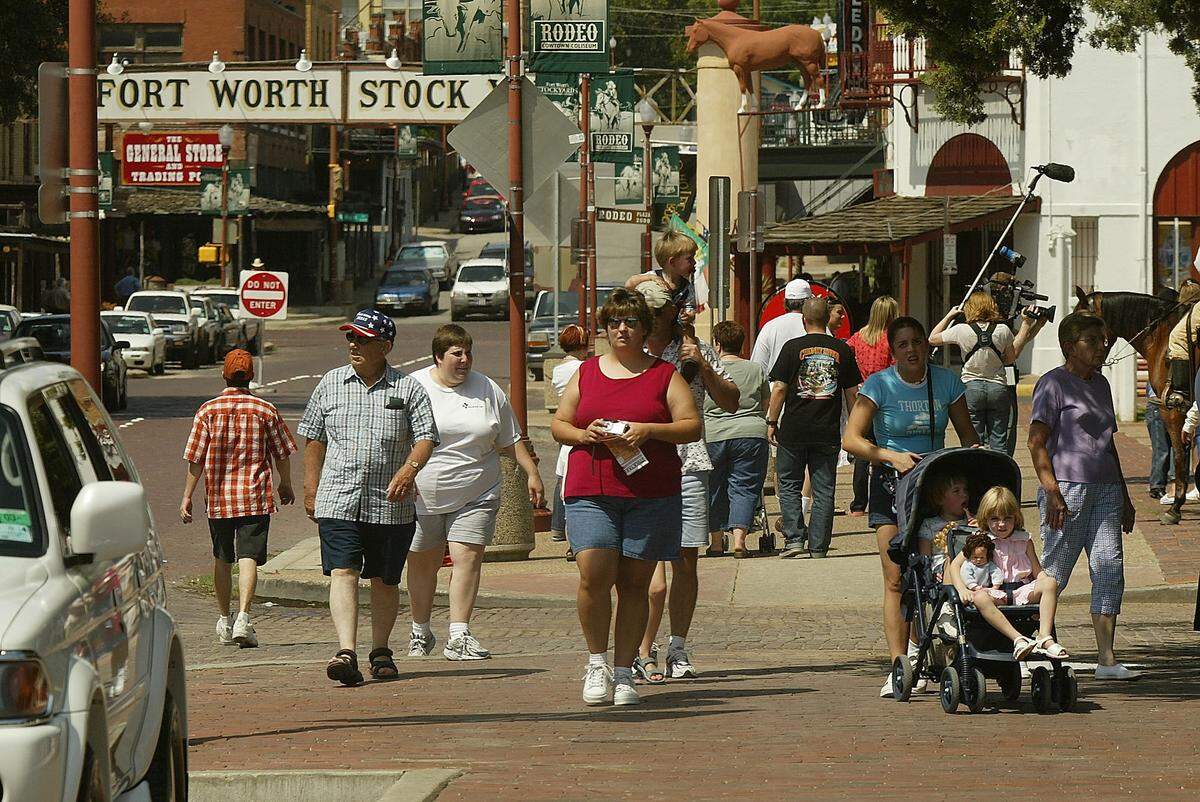 Aug. 29, 2003: Tourists walk East Exchange Avenue in the Fort Worth Stockyards.