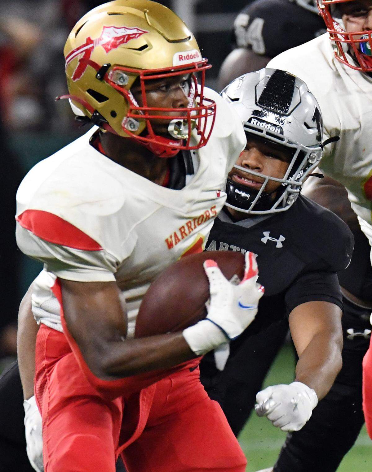 South Grand Prairie’s AJ Newberry, left escapes from Arlington Martin’s Jaiden Christopher as he scrambles out of the backfield in the second quarter of their District 8-6A football game at Choctaw Stadium in Arlington, Texas. Special/Bob Haynes