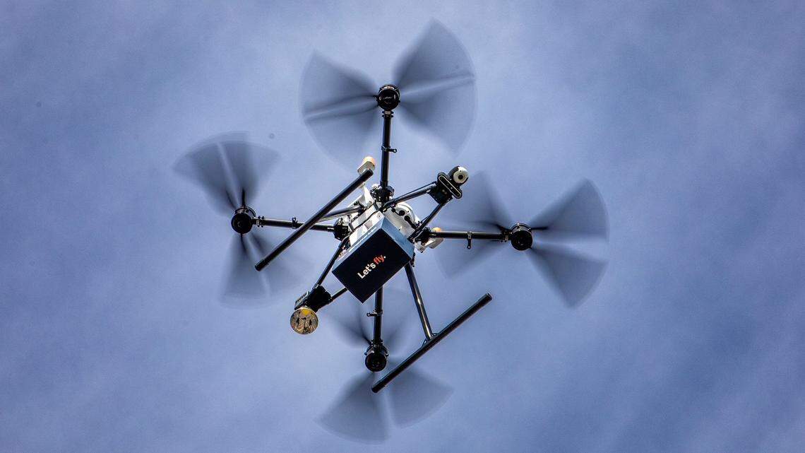 A drone test flight drops a tethered package in the parking lot of the Walmart Supercenter in Winter Haven, Floriday. Hurst is likely to become the next Tarrant County to allow drone deliveries.