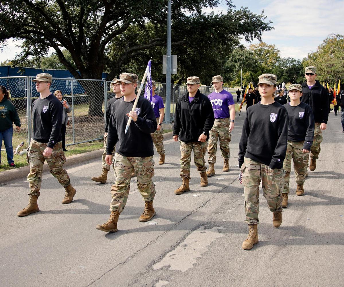 The TCU Army ROTC Horned Frog Battalion marches down Belknap Street.)
