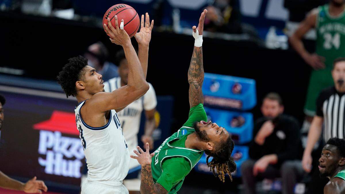 Villanova’s Jermaine Samuels (23) shoots over North Texas’ James Reese (0) during the first half of a second-round game in the NCAA men’s tournament at Bankers Life Fieldhouse, Sunday, March 21, 2021, in Indianapolis.