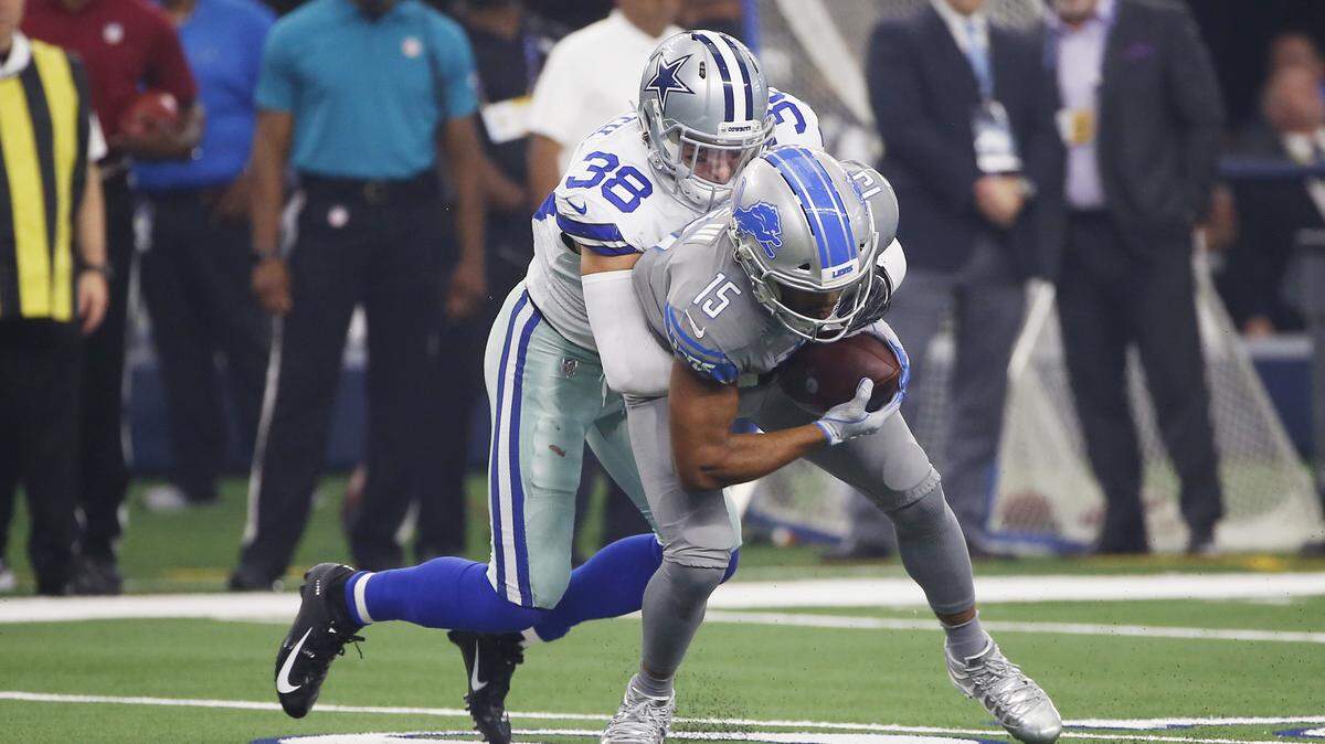Cowboys defensive back Jeff Heath tackles Detroit Lions wide receiver Golden Tate in the first half Sunday at AT&T Stadium.