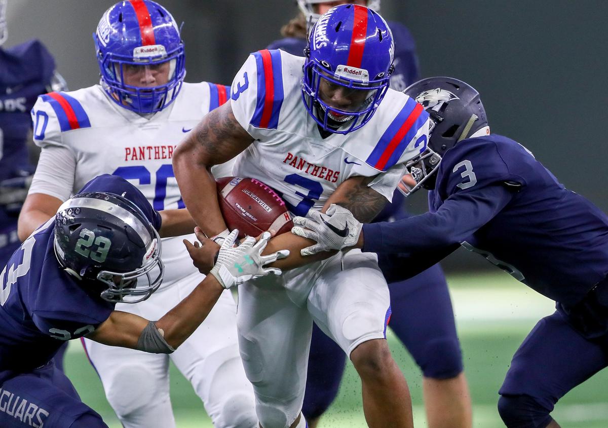 Duncanville quarterback Ja’Quinden Jackson (3) looks to get through Flower Mound defensive end Markel Session (3) and safety Chase McCall (23) during the first half of their 6A Division I area round high school football playoff game at AT&T Stadium in Arlington, Tx Saturday November 23, 2019.