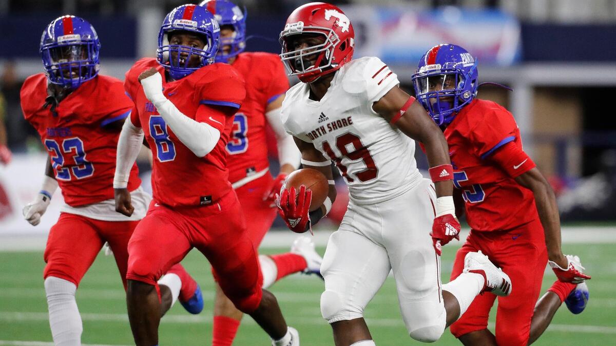 North Shore wide receiver Shadrach Banks (19) leads the Duncanville defense down field in the first half of the State 6A Division I Championship football game at AT&T Stadium, Arlington, Texas, Saturday, Dec. 22, 2018. North Shore led 29-20 at the half. (Star-Telegram Bob Booth)