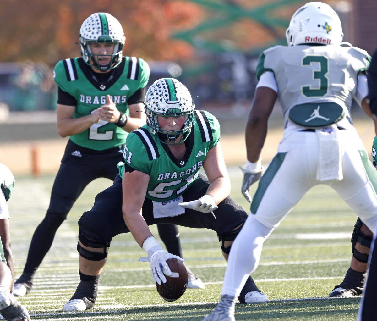 Southlake Carroll center Carey Clayton (51) snaps the ball to quarterback Angelo Renda (2) against DeSoto during the first half of a UIL Class 6A Division II semifinal on Saturday Dec. 13, 2025 at Vernon Newsom Stadium in Mansfield, Texas.