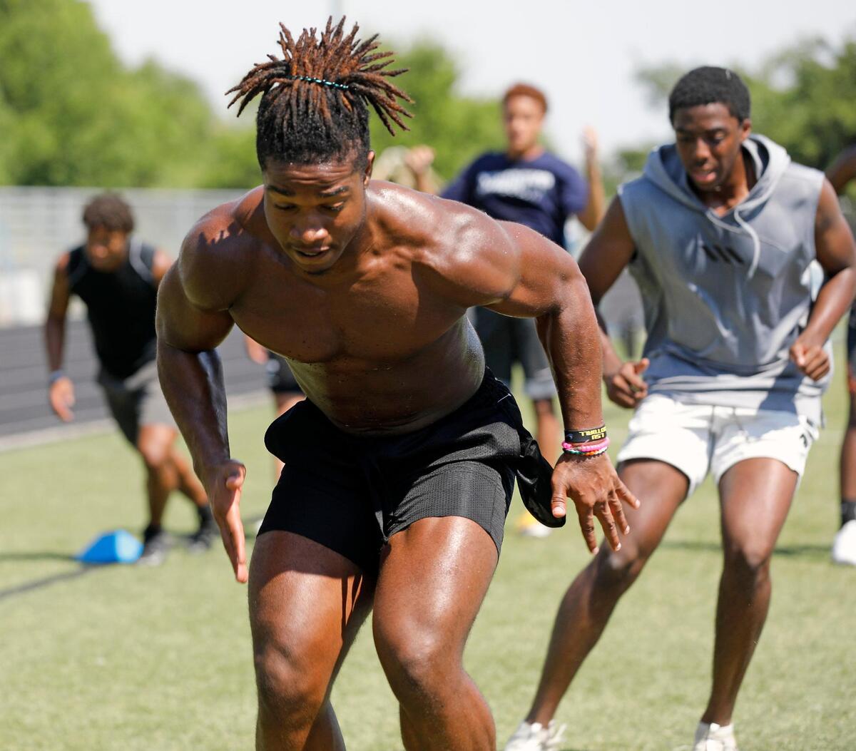 Vikings running back Emeka Megwa leads team mates through a drill during morning workouts at Nolan Catholic High School in Fort Worth, Monday, June 15, 2020. Football workouts were held during distancing for Covid-19. Field temperature was 97 during the morning workout. (Special to the Star-Telegram Bob Booth)