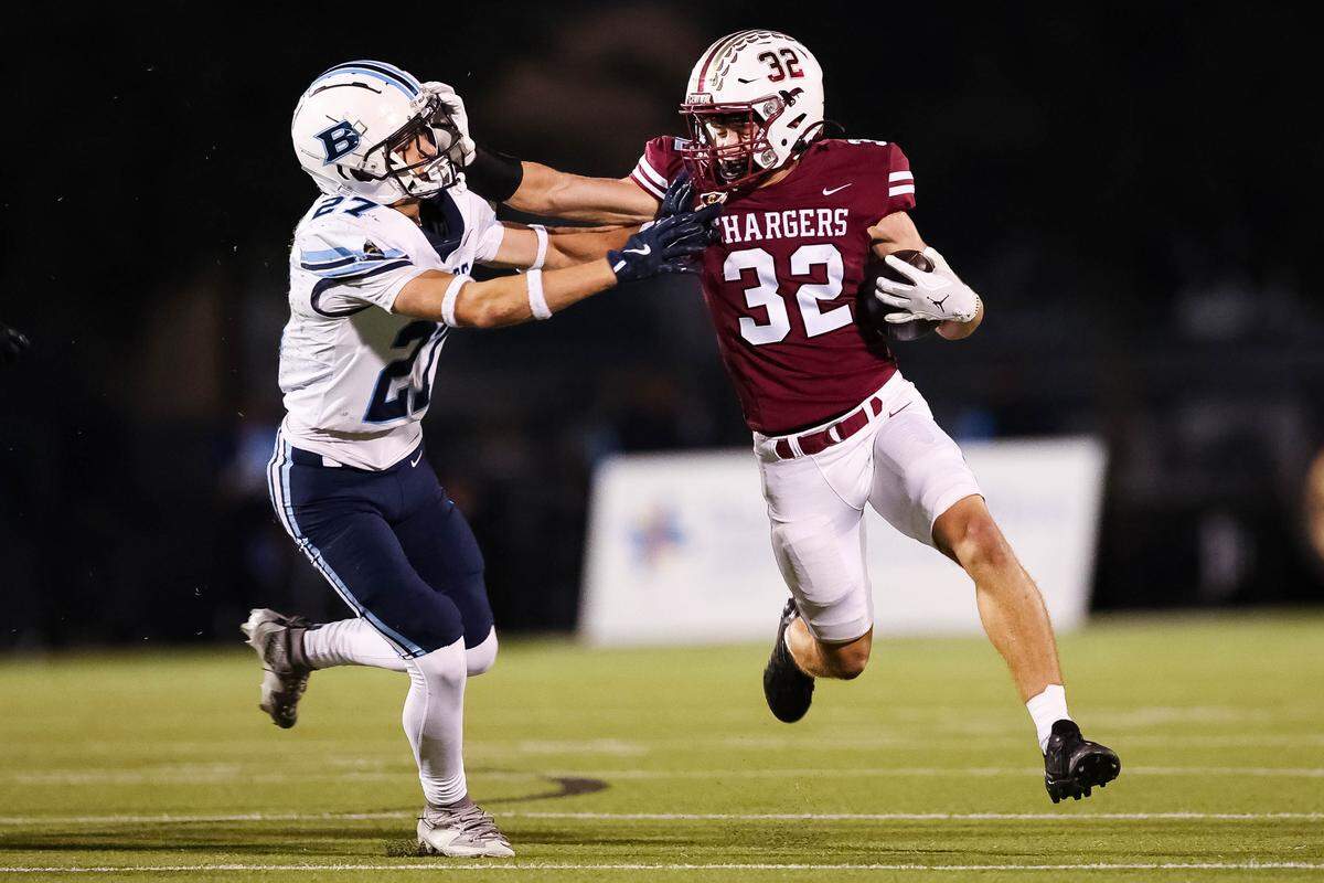 Keller Central running back Spencer Martin stiff-arms a L.D. Bell defensive back during a district game between Keller Central and L.D. Bell at Keller ISD Stadium in Keller, Texas on October 16, 2025.