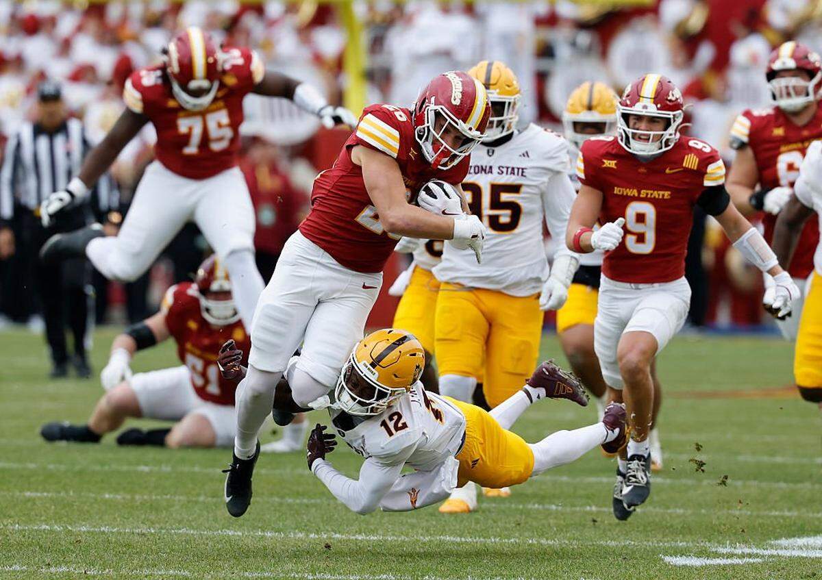 AMES, IOWA - NOVEMBER 1: Running back Carson Hansen #26 of the Iowa State Cyclones rushes for yards as defensive back Javan Robinson #12 of the Arizona State Sun Devils blocks in the first half of play at Jack Trice Stadium on November 1, 2025, in Ames, Iowa. (Photo by David Purdy/Getty Images)