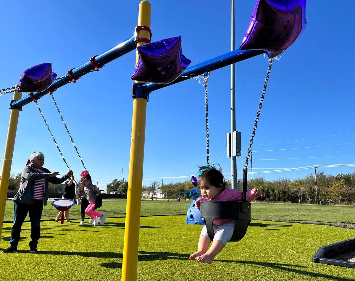 Arabella, 11 months, enjoys a swing set at Noel Angel Alvarez Playground at Clyde Pittman Park in Everman on Monday, November 20, 2023.