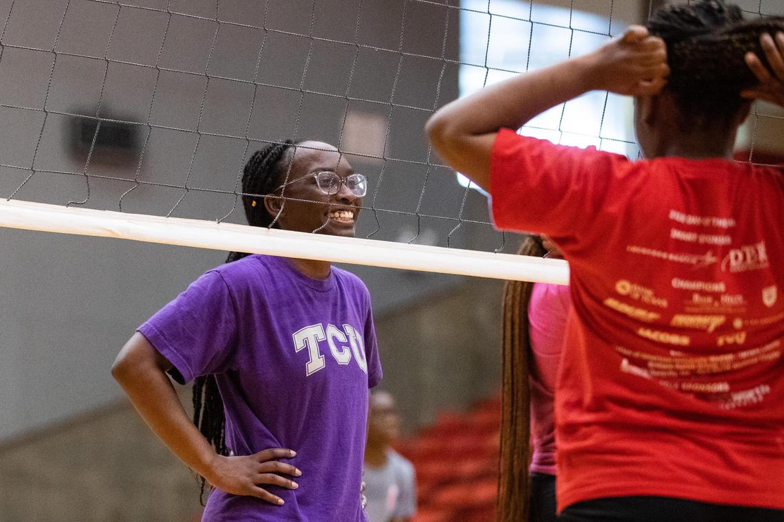 Aviyana Smith laughs with her teammate during a Young Women’s Leadership Academy volleyball practices before the team heads to playoffs for the first time Oct. 20, 2021, at Wilkerson-Greines Activity Center in Fort Worth. The team doesn’t have a home court and has to commute more than 10 minutes to the district court.