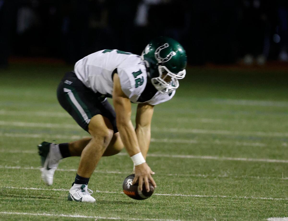 Arlington linebacker Luis Mendoza (12) picks up a fumble and returns it 25 yards for Arlington’s only score of the first half during a District 8-6A football game at C.H. Wilemon Field in Arlington, Texas, Friday, Oct. 18, 2024.