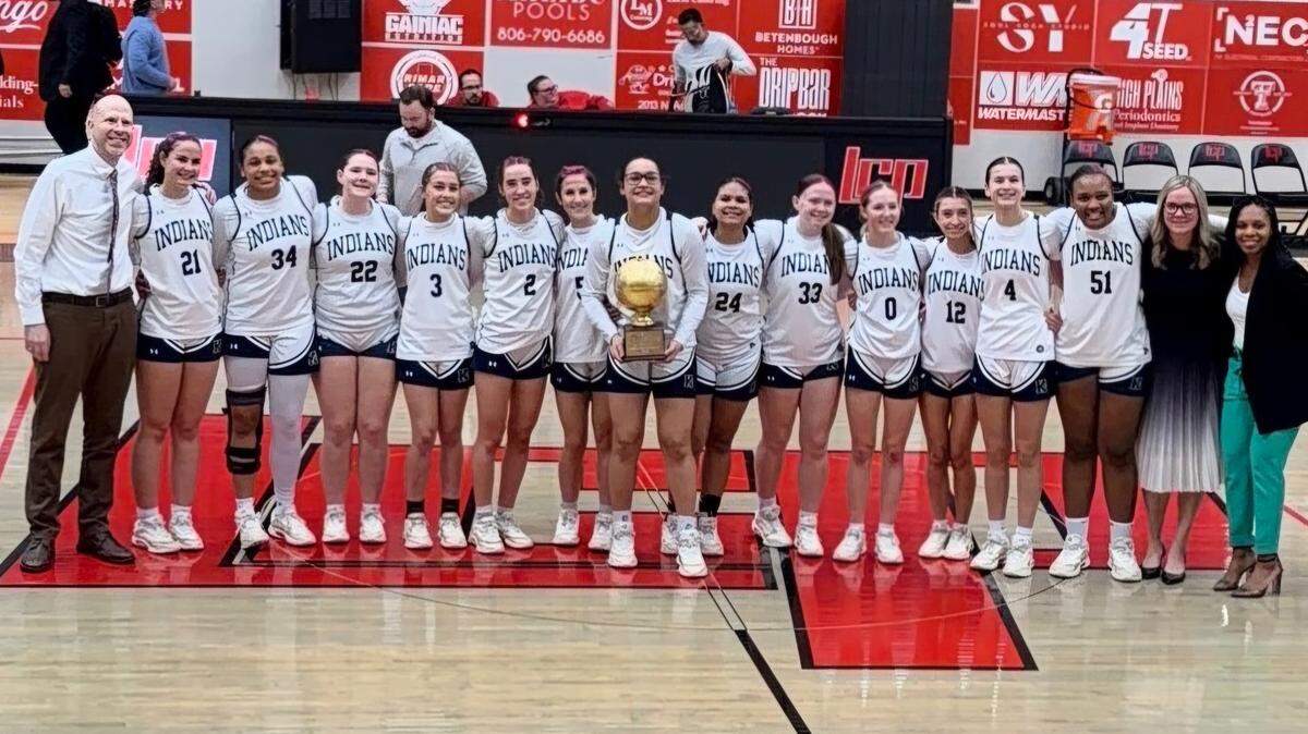 The Keller girls basketball team poses with the trophy after defeating El Paso Eastlake 47-32 in a Class 6A Division I area-round playoff on Friday, February 20, 2026 at Lubbock-Cooper High School in Lubbock, Texas.
