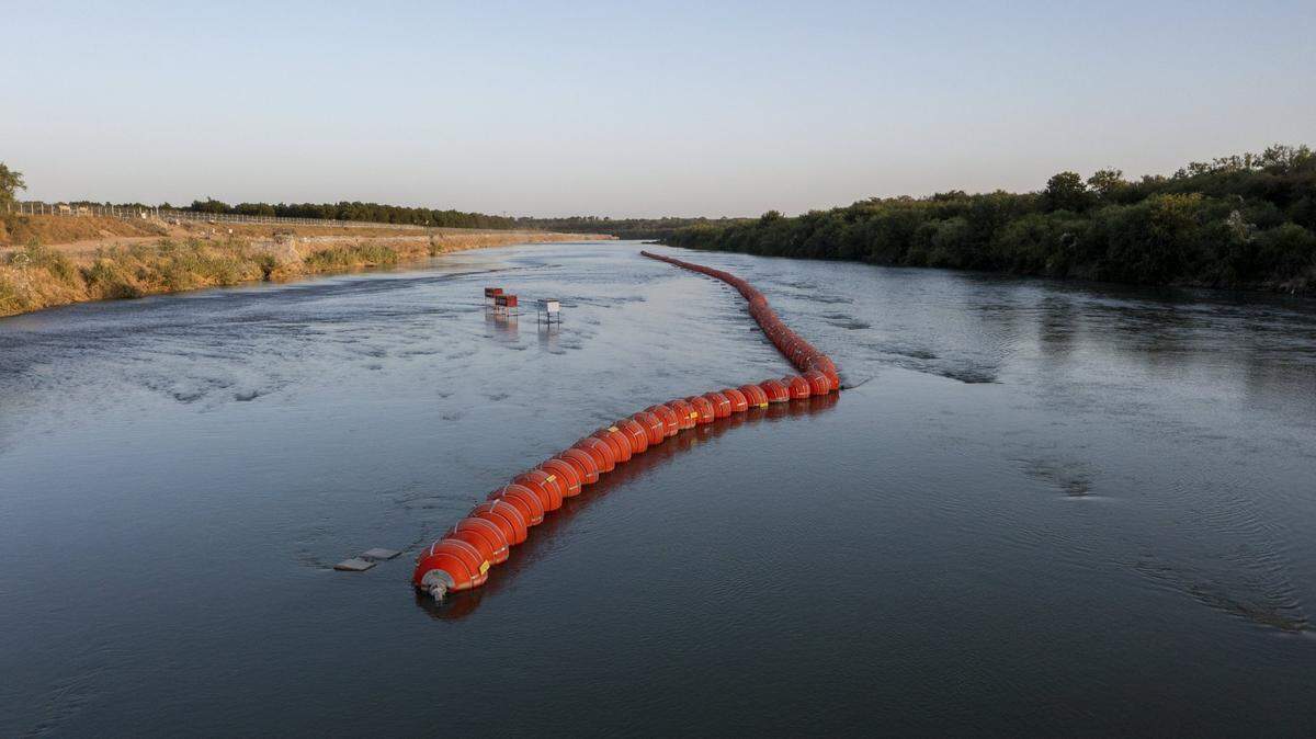 July 22, 2023; Eagle Pass, TX, USA; Buoys set on the international boundary between Mexico and the U.S. were placed by the State of Texas on the Rio Grande as a measure to prevent migrants seeking asylum from crossing into Eagle Pass, Texas from Piedras, Negras, Coahuila, Mexico. In this drone photo Eagle Pass, Texas is on the left side of the frame looking east downriver. Mandatory Credit: Omar Ornelas-USA TODAY NETWORK
