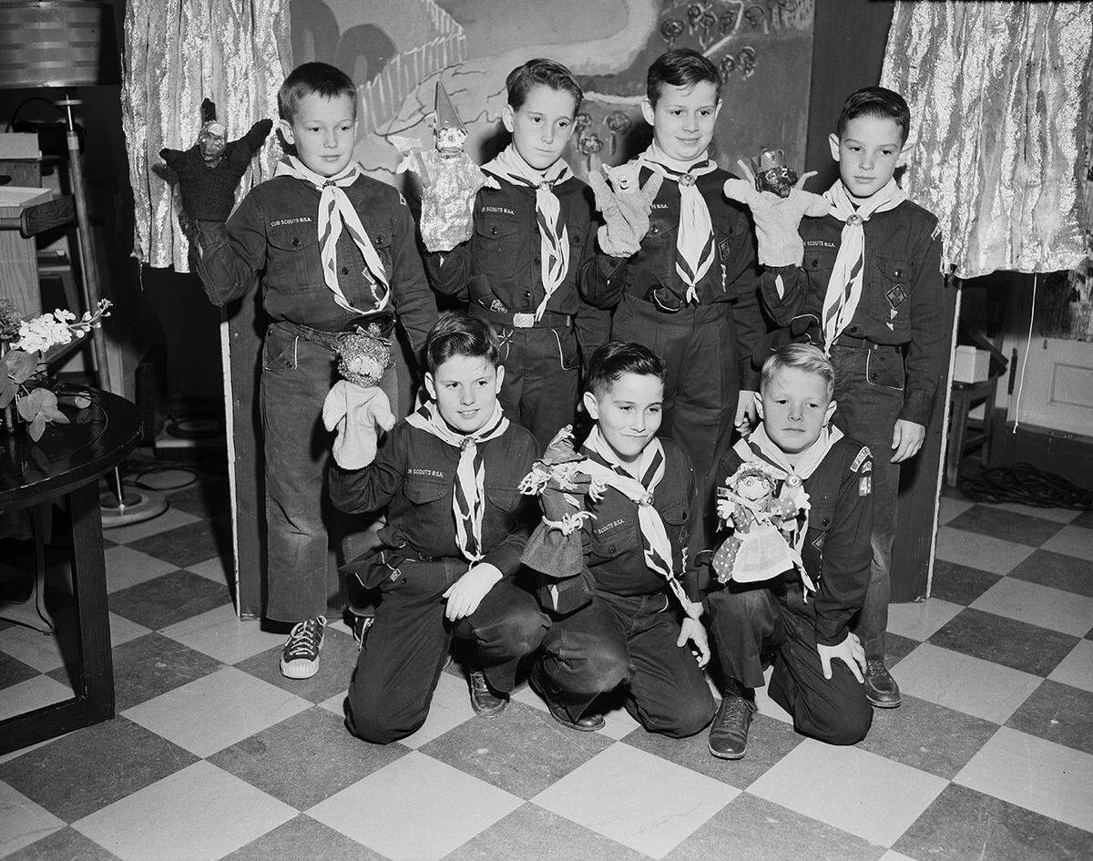 March 19, 1954: Members of Cub Scout Den 1, Pack 49, Horned Frog District of the Longhorn Council of Boy Scouts, display puppets made for a skit presented to children at W.I. Cook Memorial Hospital Center for Children. They are, left to right, front row, Michael Smith, Kenneth Herburger and Pete Gray; back row, Burton Tims, Taber Chamberlain, Arthur Weinman and Ronald Greer.