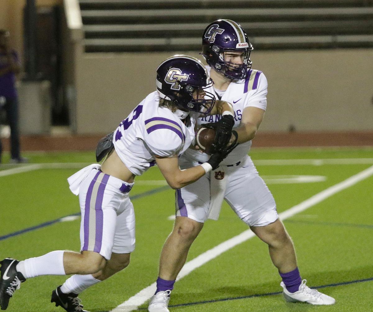 Chisholm Trail’s Joey McGowen hands off to Ethan Westover during a UIL football game at Farrington Field Stadium on Thursday, October 4, 2024.