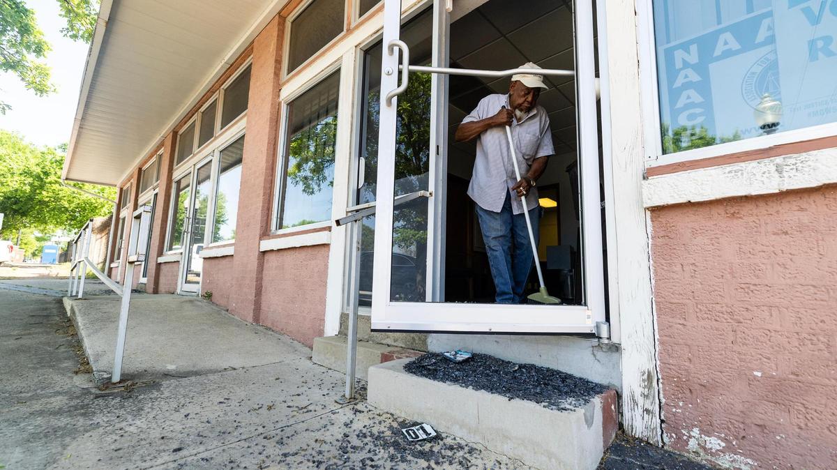 James Mallard, a lifetime member of the NAACP Fort Worth Chapter, cleans up broken glass from one of the vandalized doors of the Fort Worth Tarrant County NAACP building in Fort Worth on Tuesday, April 15, 2025.