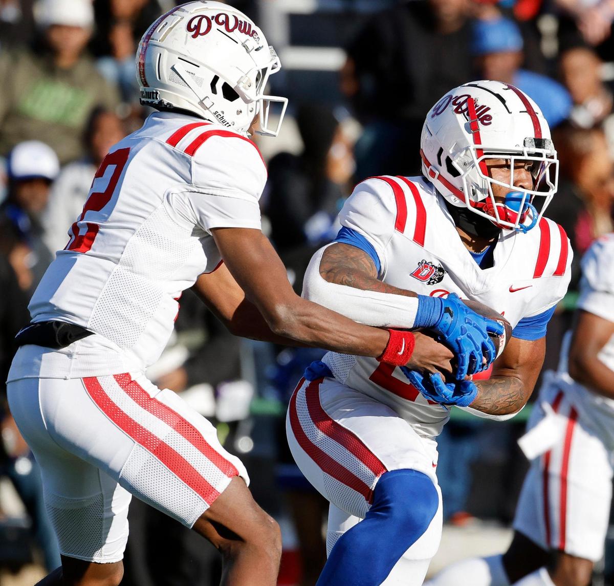 Duncanville quarterback Keelon Russell (12) hands the ball to running back Caden Durham (29) during the first half of a UIL Conference 6A Division I state semifinal football playoff game at Mesquite Memorial Stadium in Mesquite, Texas, Saturday, Dec. 09, 2023. Duncanville led North Crowley 24-0 at the half.