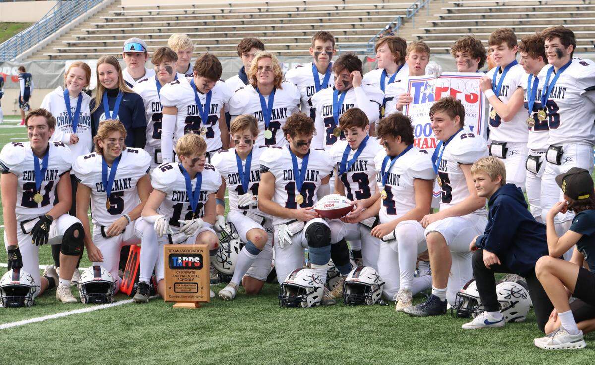 The Fort Worth Covenant Classical football team poses with their hardware after defeating Huntsville Alpha Omega in the TAPPS Six-Man Division II Championship game on Thursday, Dec. 5, 2024 at Waco ISD Stadium in Waco, Texas.