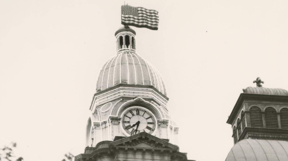 An electric U.S. flag with lighted stars and stripes flashed atop the neon-outlined Tarrant County courthouse from 1954 to 1959.