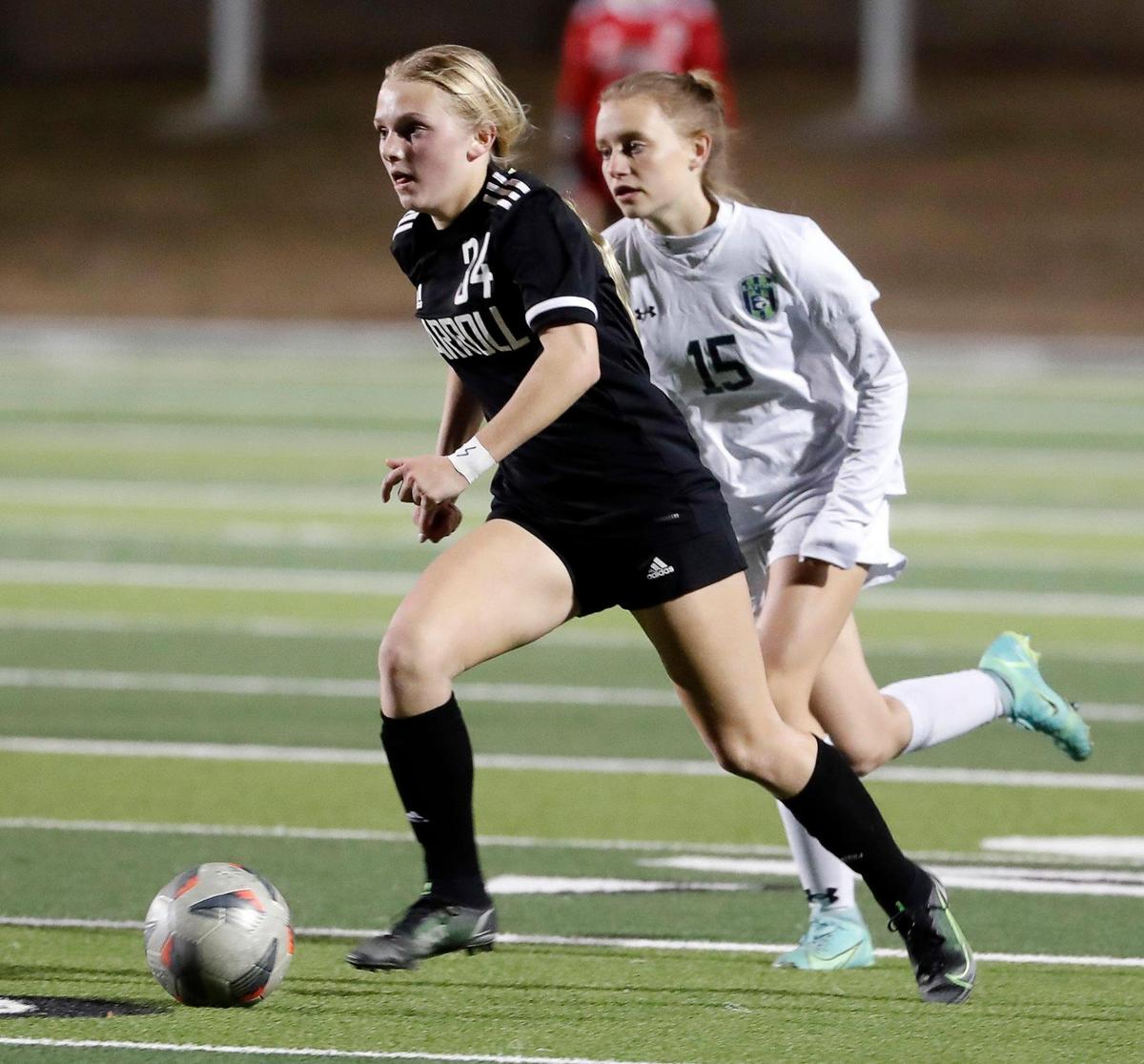 Carroll’s Hannah Jordan takes the ball down the pitch in front of Eaton’s Hannah Oberbeck during a high school girls soccer game at Dragon Stadium in Southlake, Texas, Wednesday, Feb. 09, 2022. Carroll defeated Eaton 8-1. (Special to the Star-Telegram Bob Booth)