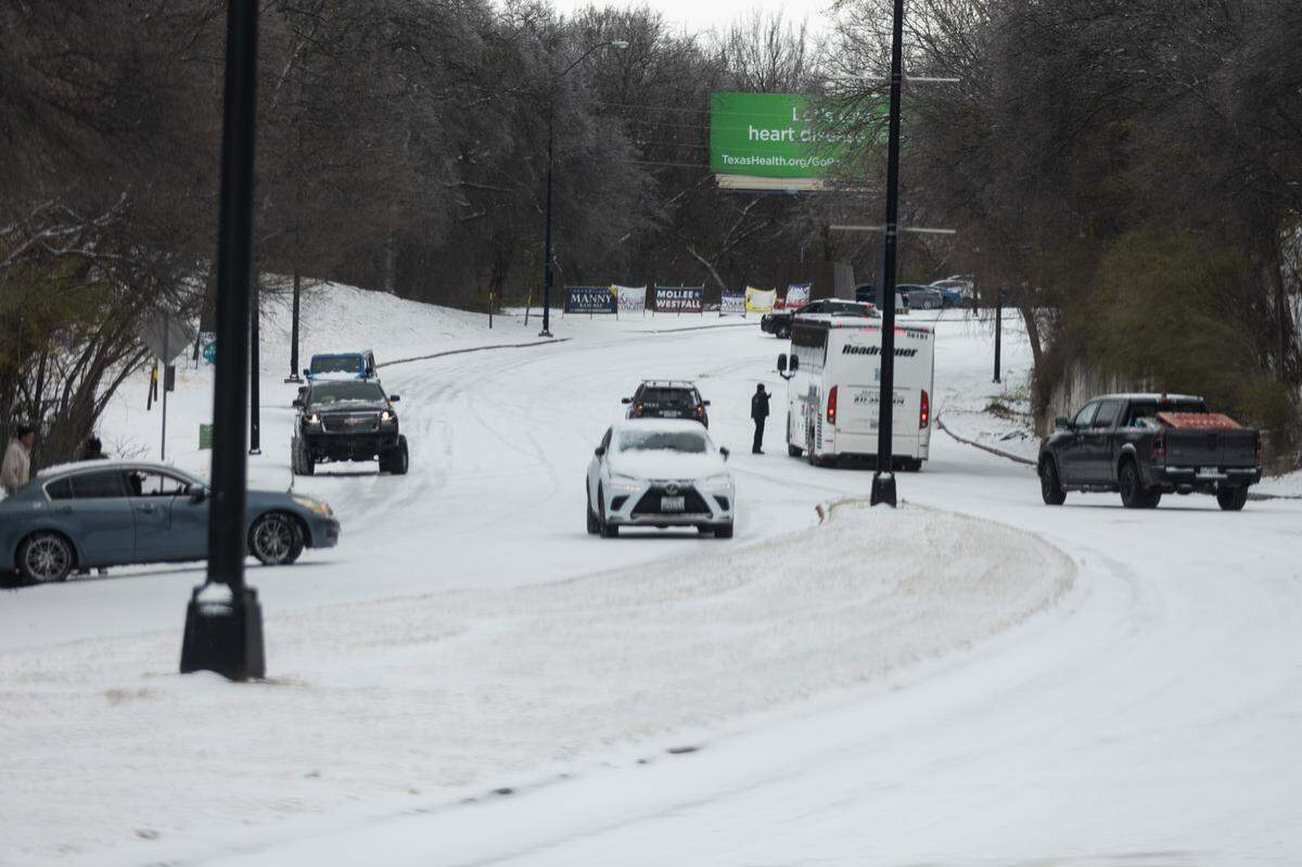 Cars spin out on an icy section of University Drive during a winter storm Thursday, Feb. 3, 2022 in Fort Worth.
