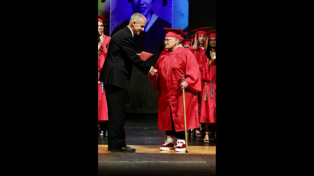 Glen Rose Superintendent Trig Overbo awarded a high school diploma to 81-year-old Nancy Davis during the high school graduation ceremony on May 27. Davis dropped out of Glen Rose High School when she was 18.