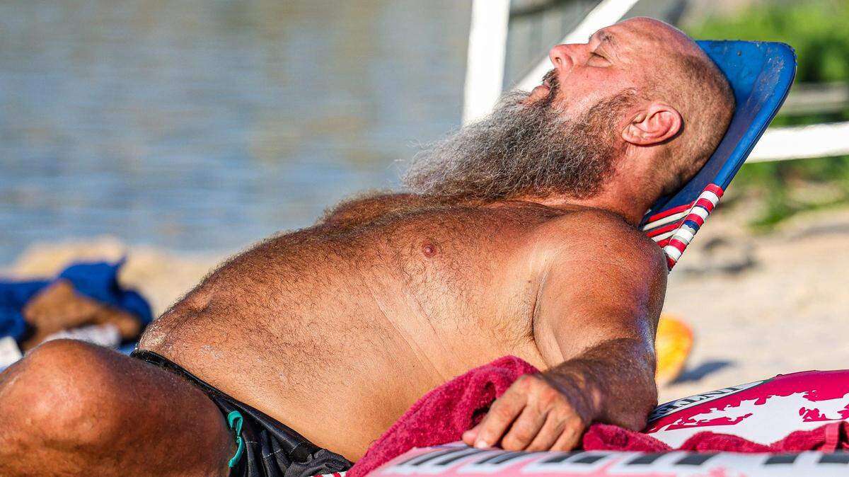 David Hume sunbathes on the water during the heatwave for the Rockin’ The River Live on the Trinity Concert event at the Panther Island Pavilion in Fort Worth on Thursday, July 13, 2023.