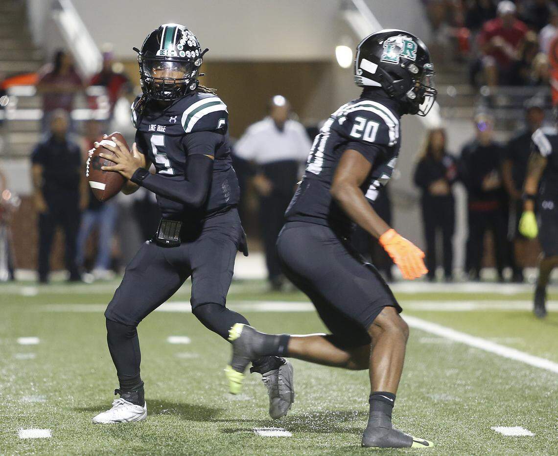 Mansfield Lake Ridge quarterback Deshawn Edwards (5) looks for a receiver against Euless Trinity during their Class 6A Division I bi-district game on Friday, November 14, 2025 at Newsom Stadium in Mansfield Texas.