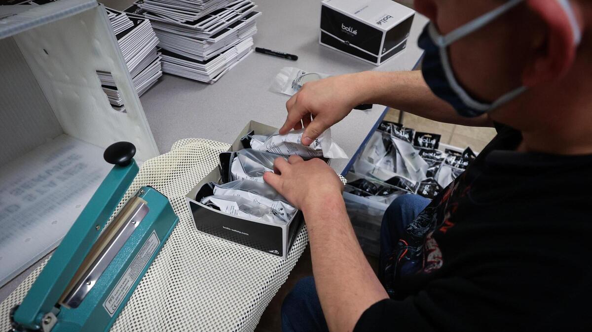 Nick Frey packages safety glasses at My Health My Resources of Tarrant County in this file photo from November 2021. MHMR provides services like job training and health care to thousands of people with mental illnesses or intellectual disabilities.