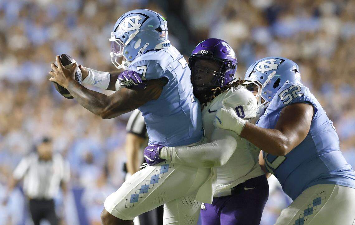 TCU’s Zach Chapman (0) wraps up North Carolina quarterback Gio Lopez (7) during the first half of North Carolina’s game against TCU at Kenan Stadium in Chapel Hill, N.C., on Monday.