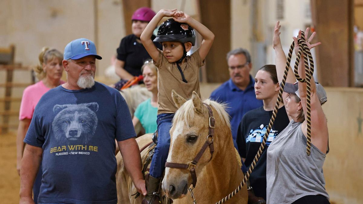 MJ Hernandez, riding Bullseye, performs a command from volunteer Starla Wachsmann at All Star Equestrian Foundation in Burleson on May 23. Places like the foundation are part of a network of doctors, therapists and specialists MJ sees to get the care he needs.