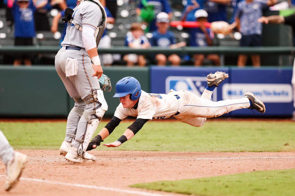 A Robinson player dives head first into home plate against Brock in the UIL Class 4A Division II baseball state championship game on Friday, June 5, 2026, at Dell Diamond in Round Rock, Texas.